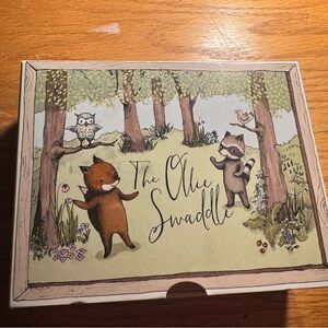 The Ollie Swaddle with Woodland Creatures in Green and Brown